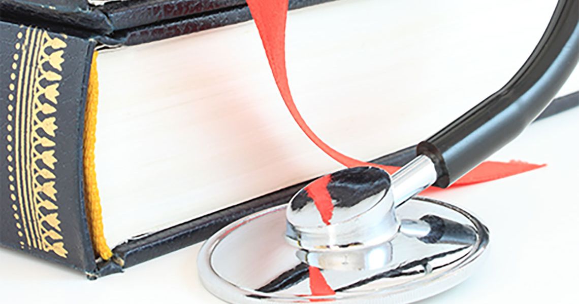 A book and stethoscope on the table