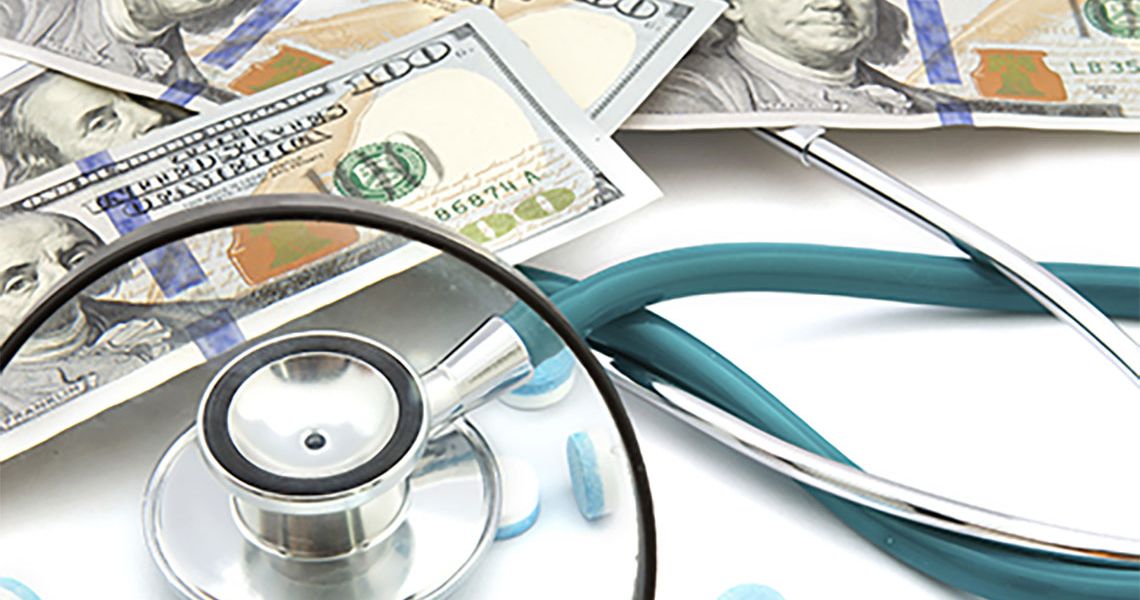 Stethoscope and money on a white table